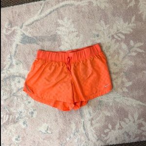 Neon orange Nike shorts